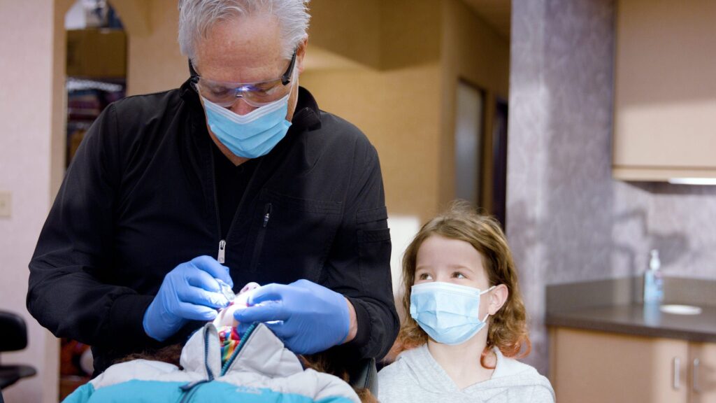 dr. roeder wearing a mask and gloves