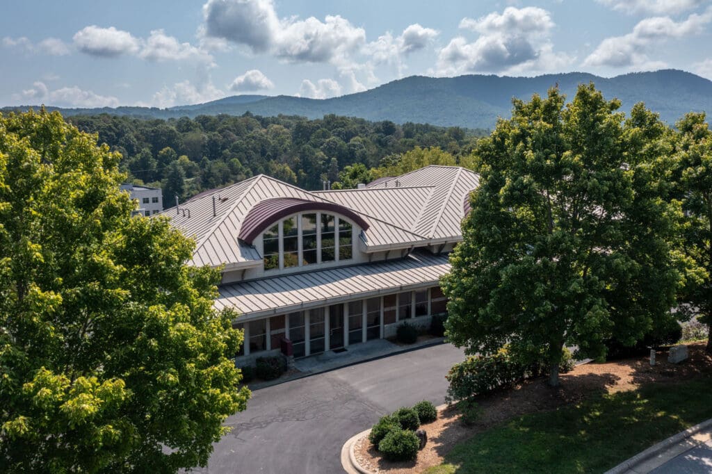 the Roeder Orthodontics building with trees and mountains in the background