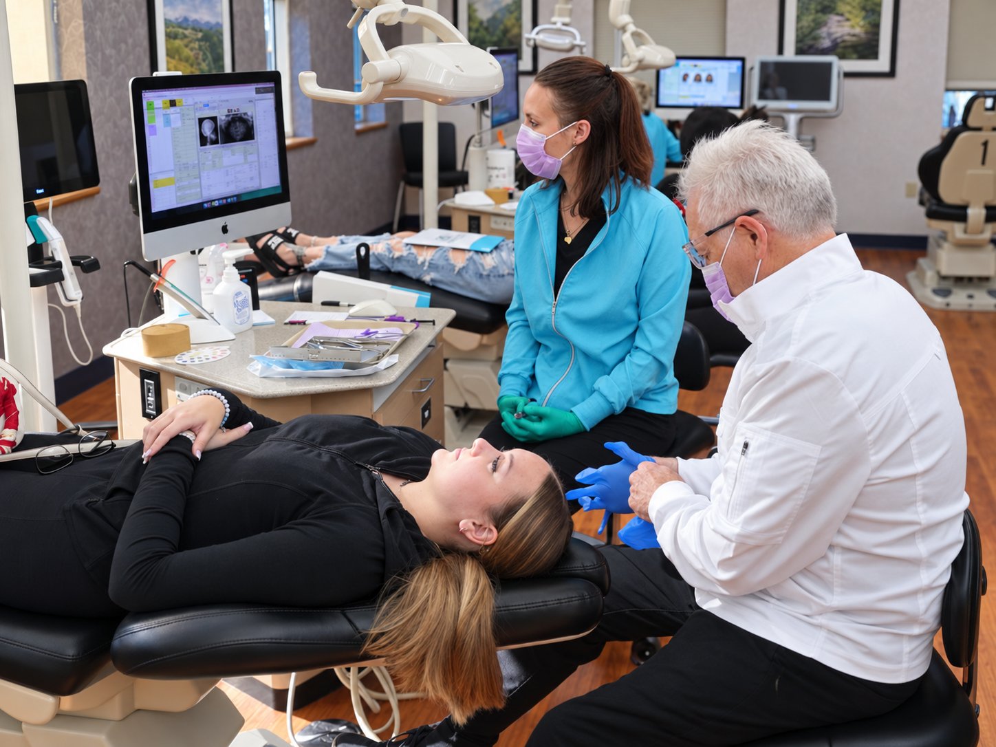 Dr. Roeder and an assistant treating a patient in the open treatment area